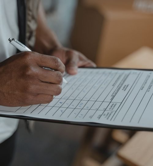 Why VTAR Close-up of person writing on form attached to clipboard, capturing the diligent process.